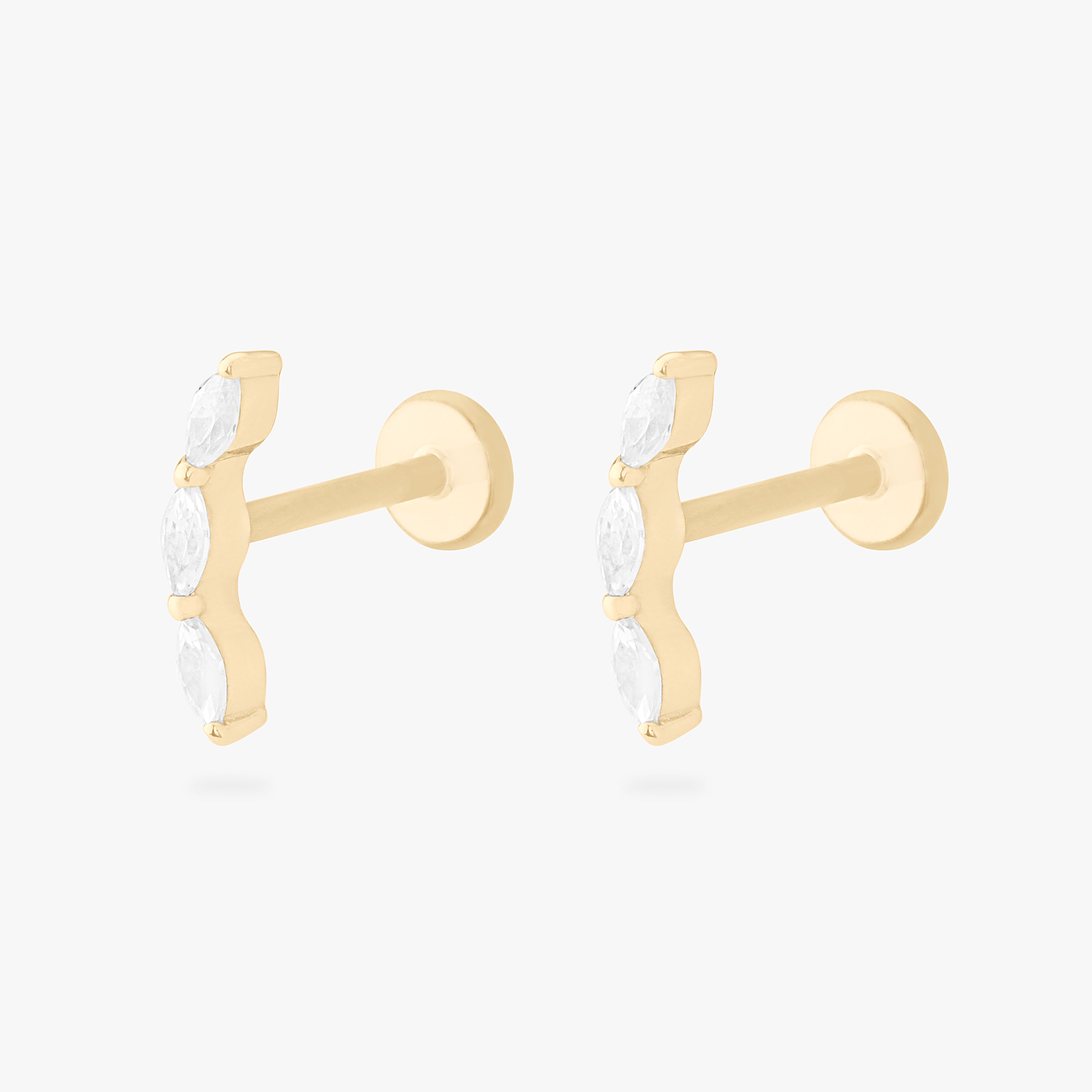 This is an image of a pair of 14k gold flatback studs with 3 clear, pear-shaped cz's in a curved line. [pair] color:null|14k gold/clear