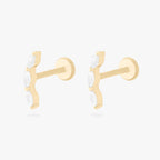 This is an image of a pair of 14k gold flatback studs with 3 clear, pear-shaped cz's in a curved line. [pair] color:null|14k gold/clear