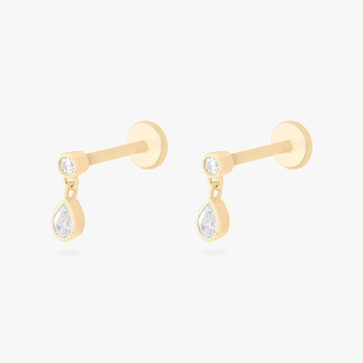 This is an image of a pair of 14k gold flatback studs with pear-shaped, bezel set clear cz stones dangling from other pear-shaped, bezel set clear cz stones.. [pair] color:null|14k gold/clear