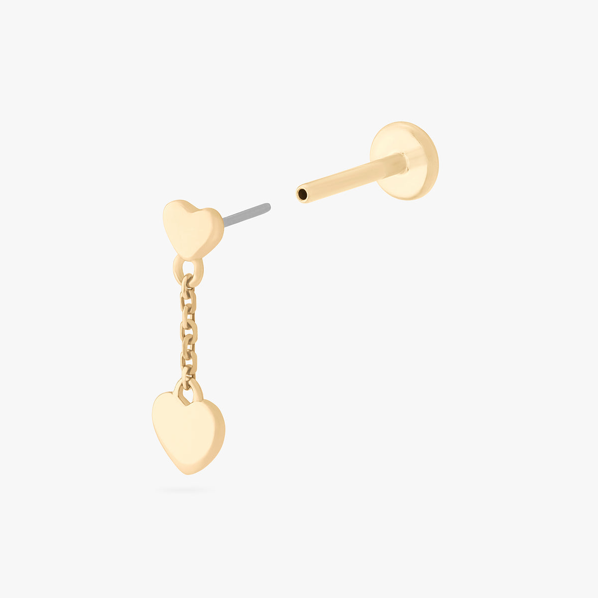 This is an image of a 14k gold flatback that is heart shaped with a gold shaped heart dangling from it. color:null|14k gold/clear