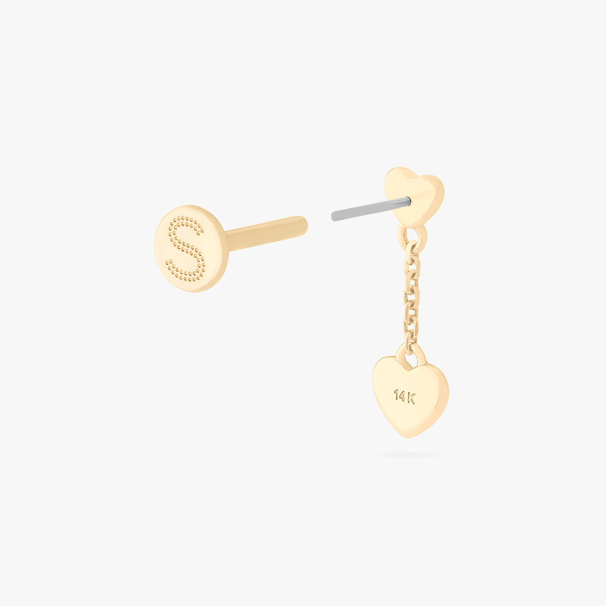 This is an image of a 14k gold flatback that is heart shaped with a gold shaped heart dangling from it. color:null|14k gold/clear