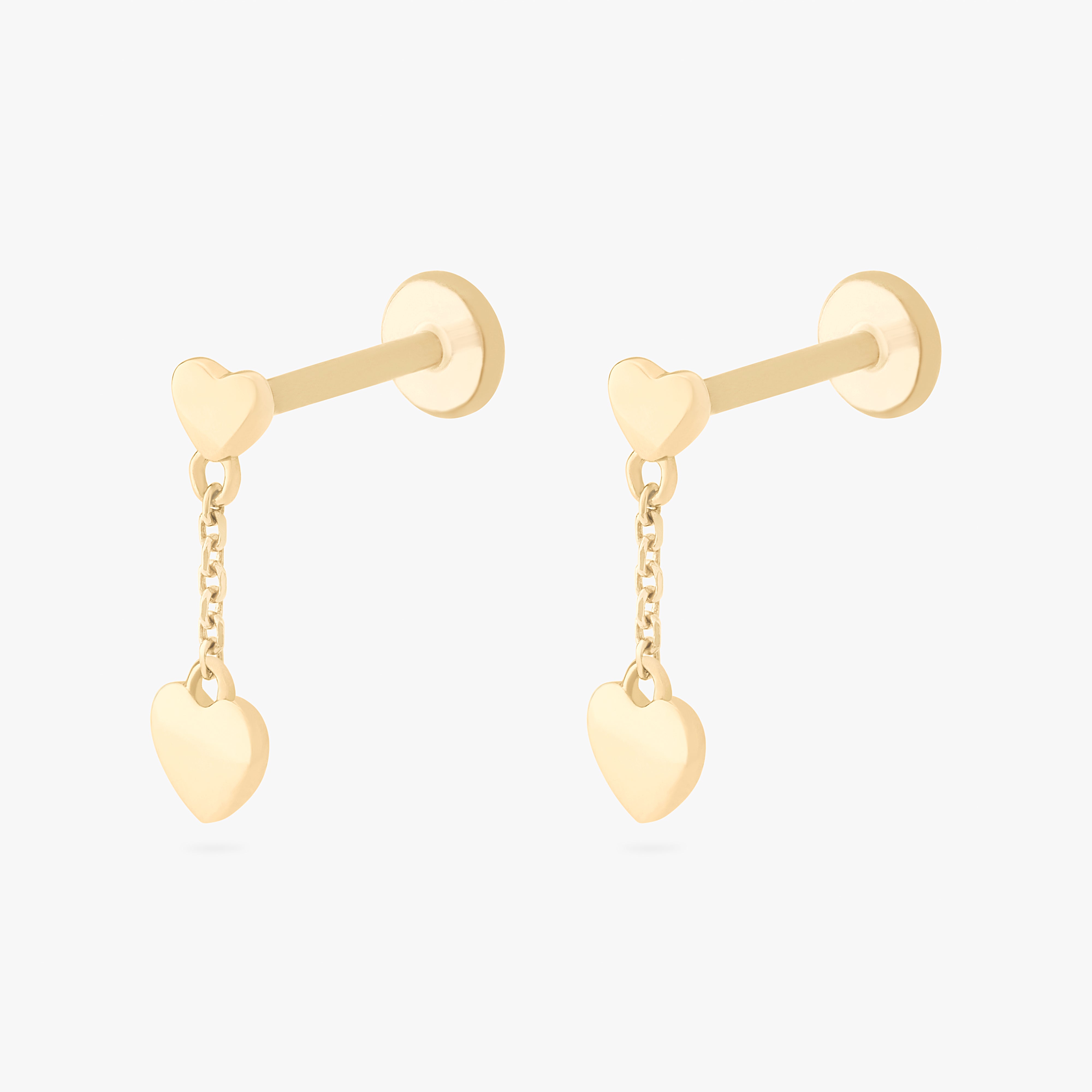 This is an image of a pair of 14k gold flatbacks that are heart shaped with gold shaped hearts dangling from them. [pair] color:null|14k gold/clear