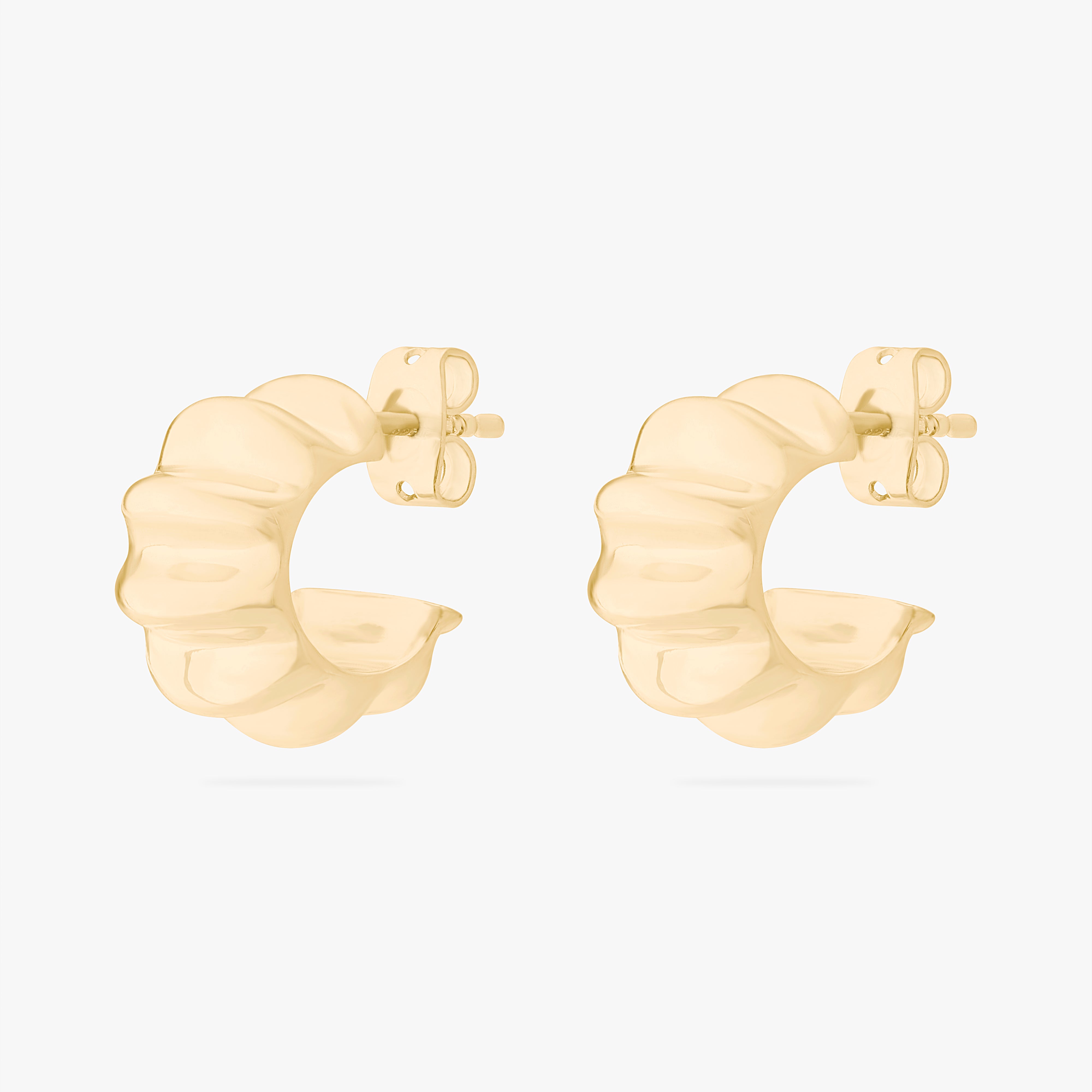 This is an image of a pair of gold toned butterfly back earrings that have ridged detailing along the edge. [pair] color:null|gold