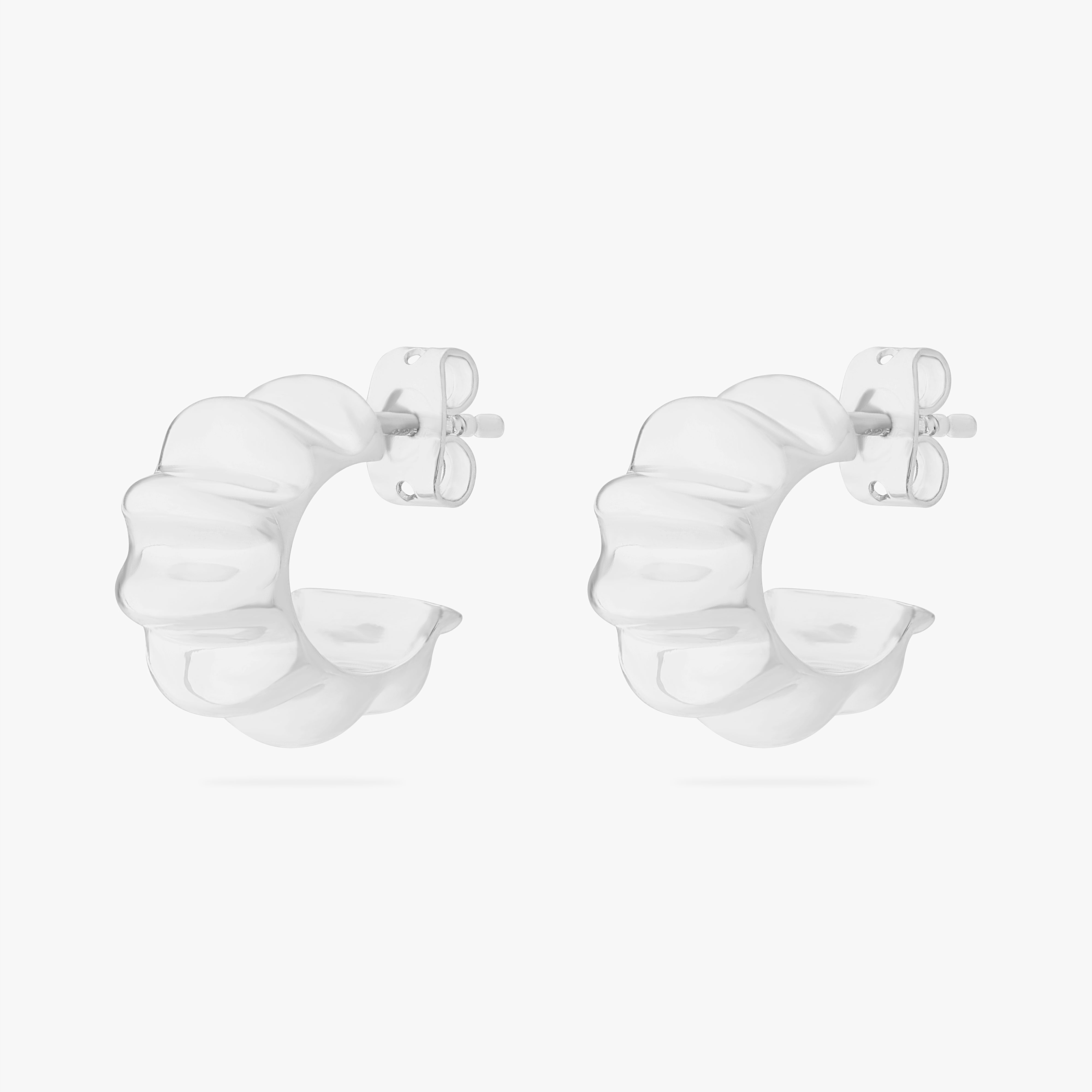 This is an image of a pair of silver toned butterfly back earrings that have a ridged detailing along the edge. [hover] color:null|silver
