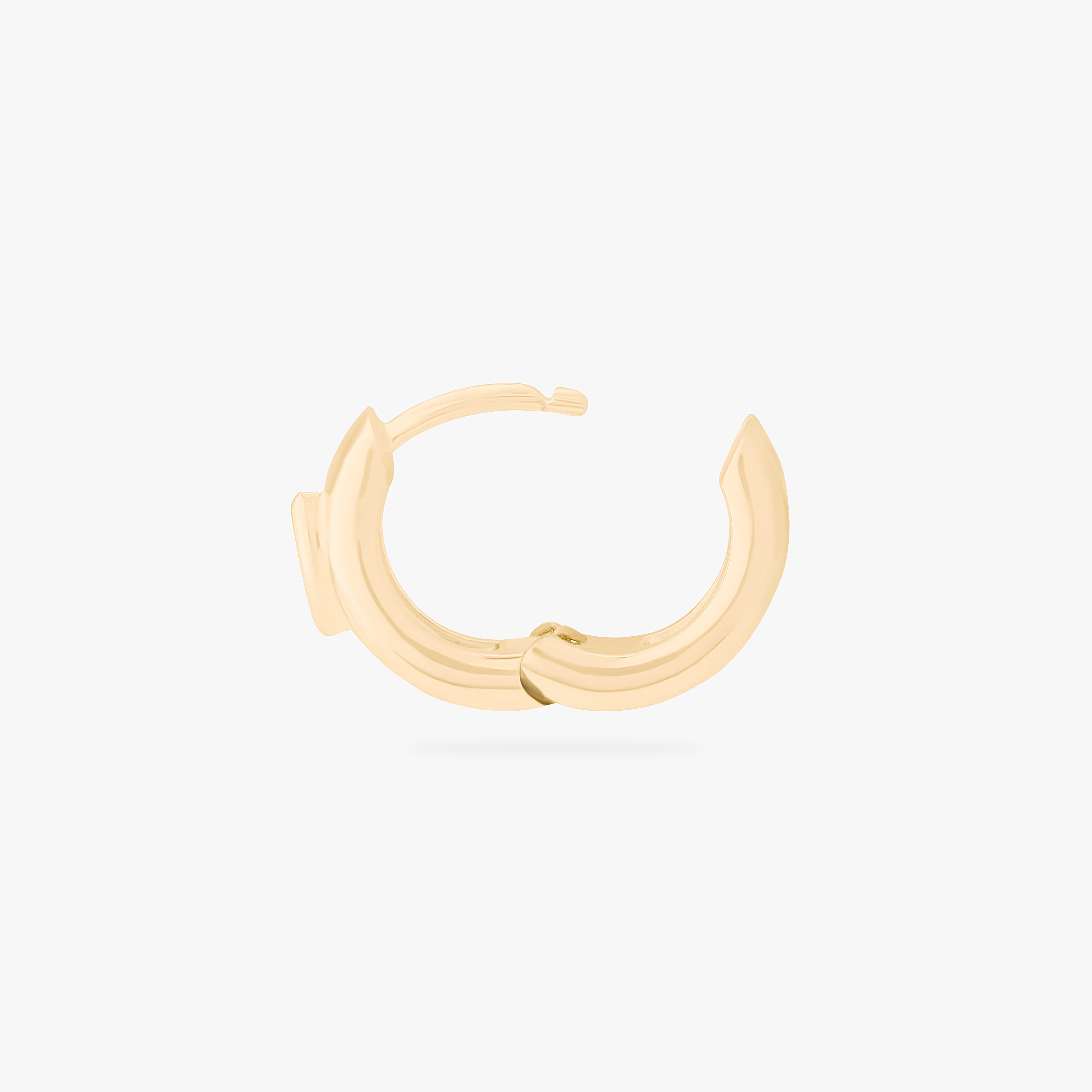 This is an image of a gold toned huggie that is chunky and has a marquise shaped cz in it. color:null|gold/clear