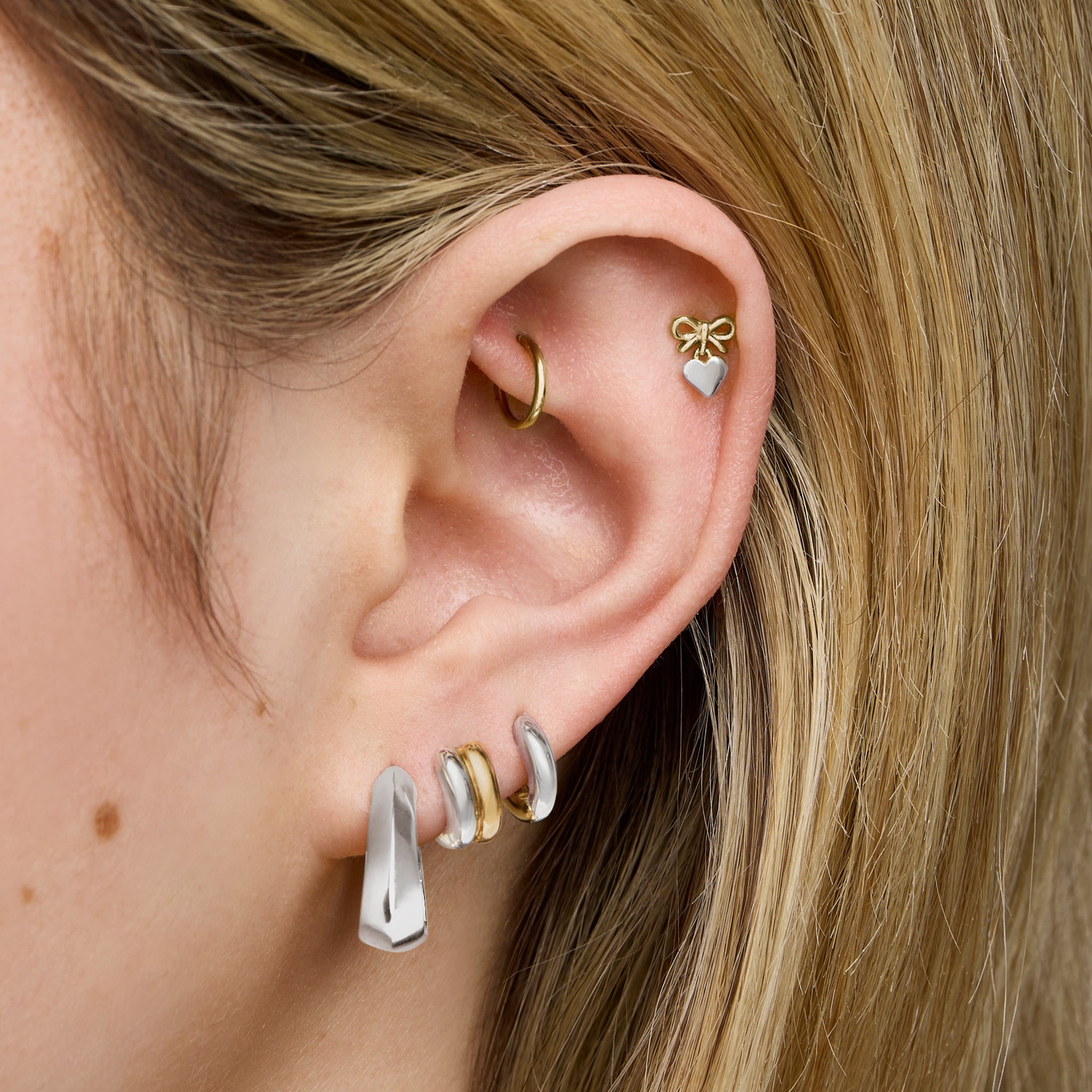 This is an image of a silver toned triangle-shaped hoop. [hover] color:null|silver