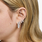 This is an image of a silver toned square hoop with a butterfly back. [hover] color:null|silver