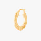 This is an image of a 14K gold plated hoop that has a fluted, shell-like finish. 