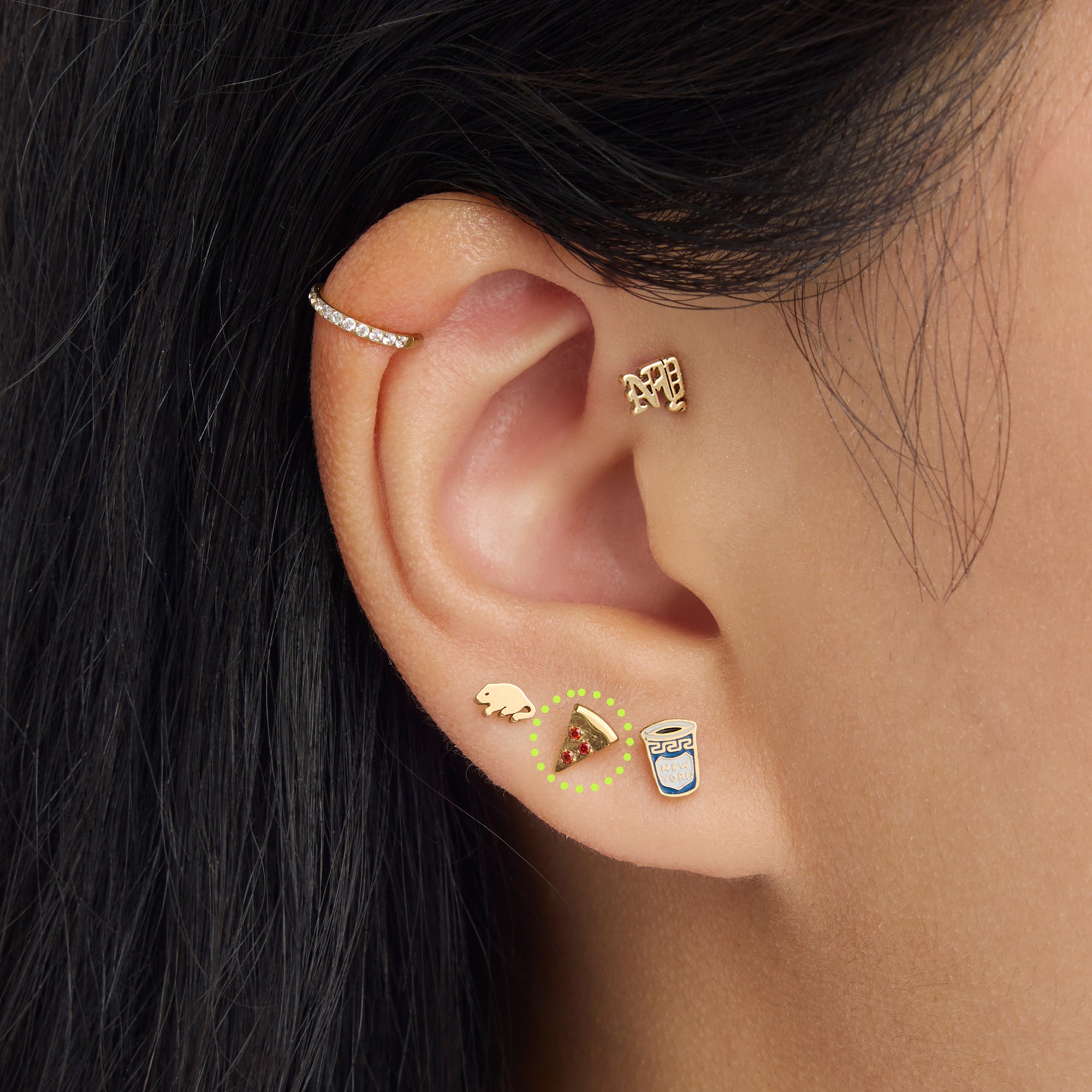 on ear photo with a circled pizza flatback stud with red stone accents in gold [hover] color:null|gold