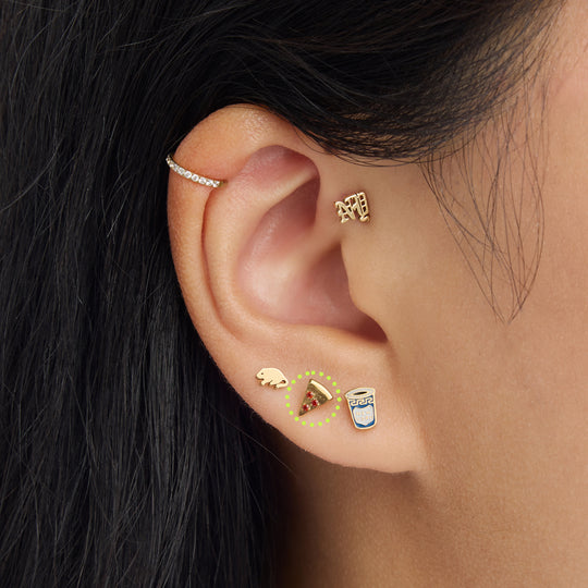 on ear photo with a circled pizza flatback stud with red stone accents in gold [hover] color:null|gold