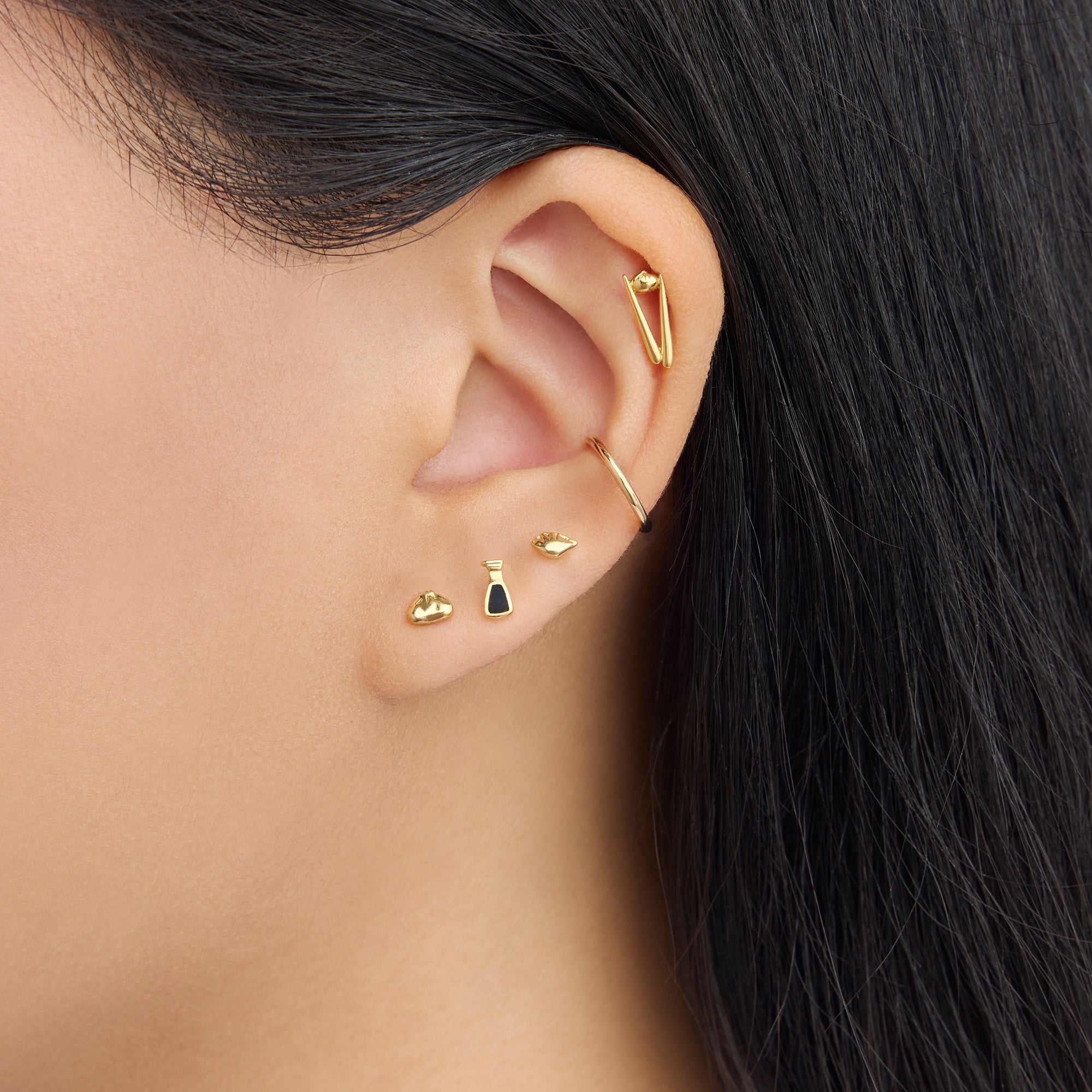 collaboration collection between DTF x Studs featuring a flatback with a steamed dumpling in gold [hover] color:null|gold