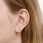 This is an image of a silver toned titanium flatback stud that is shaped like a cat. This flatback top has a kitten face, and the flatback post has the kitten body. This image is a rotating GIF displaying both sides of the flatback studs on an ear. 