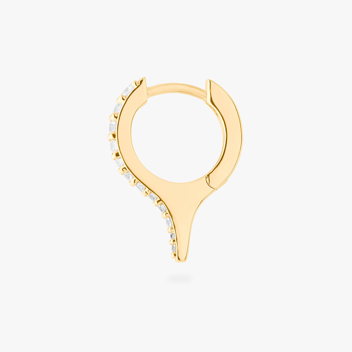 Gold huggie with a spike and small clear stones on a white background, side view