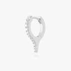 Silver huggie earring with a spike and small clear stones on a white background