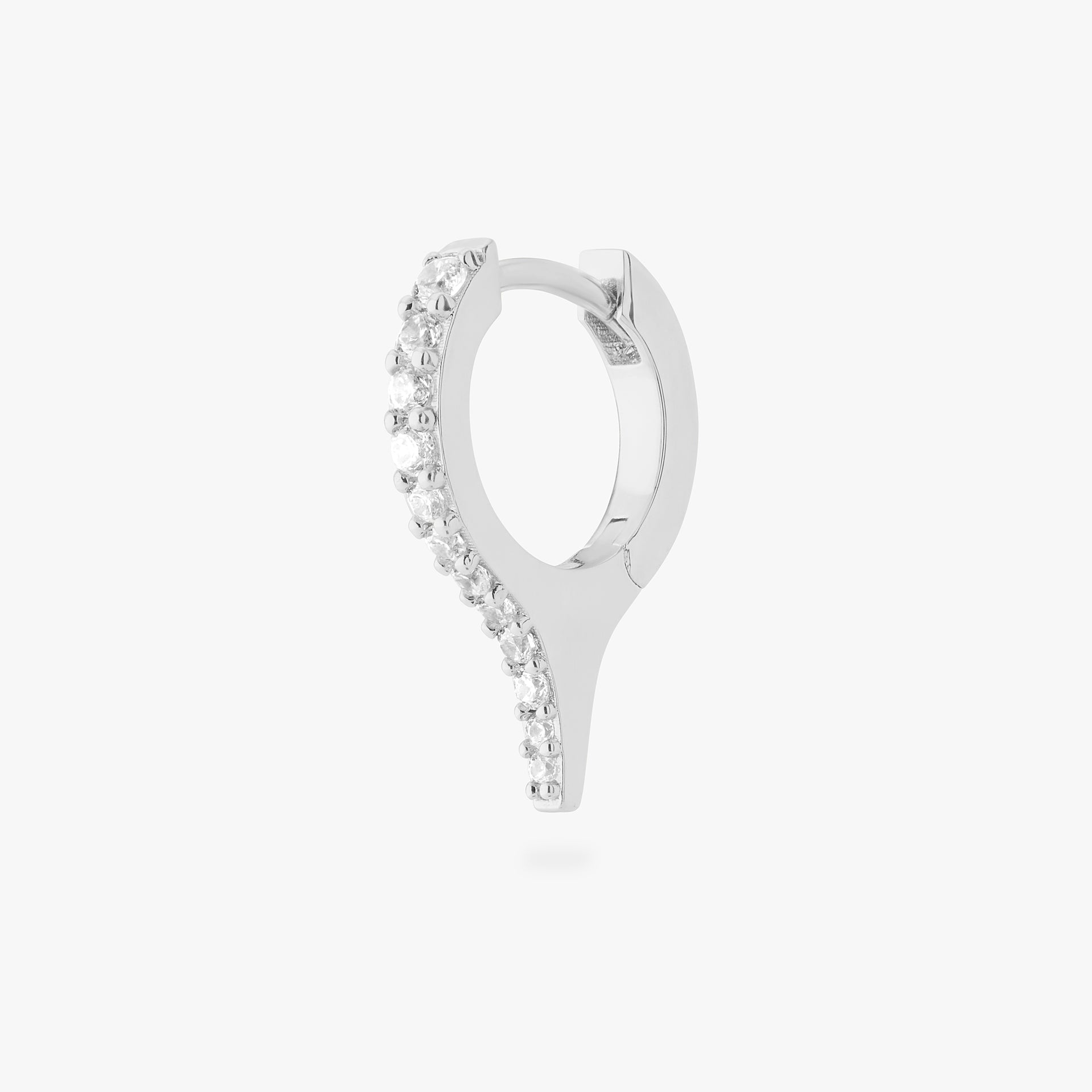 Silver huggie earring with a spike and small clear stones on a white background - Main view