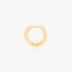 This image displays a 14K gold plated chunky huggie that features twinkle star shaped engravings with crystal CZ stones throughout the huggie against a white background. This image focuses on the side view of the huggie.