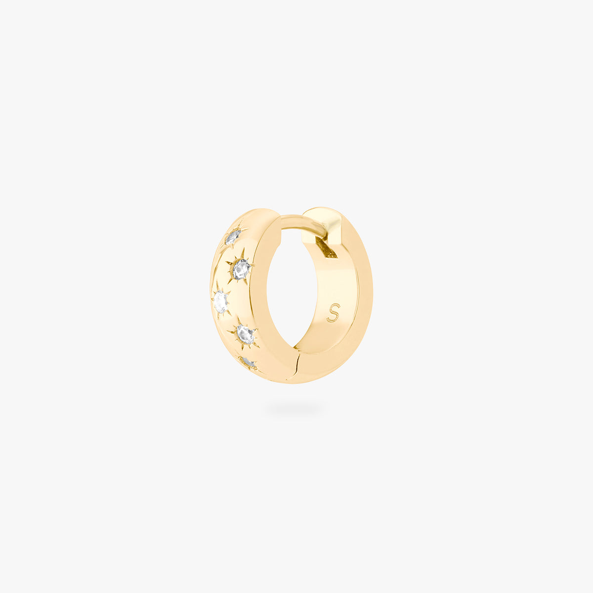 This image displays a 14K gold plated chunky huggie that features twinkle star shaped engravings with crystal CZ stones throughout the huggie against a white background. 