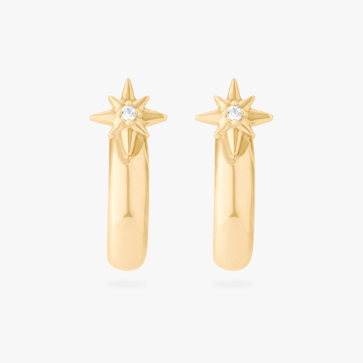 This is an image of a pair of 14K gold plated studs with twinkle stars with  crystal CZs that are shaped like hoops against a white background.