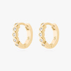 Gold hoop earrings with embedded stones on a white background