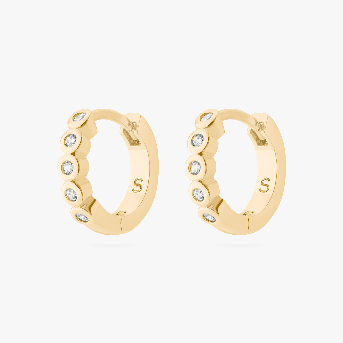 Gold hoop earrings with embedded stones on a white background