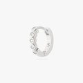 Silver hoop earring with embedded stones on a white background