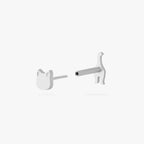 This is an image of a silver toned titanium flatback stud that is shaped like a cat. The top which is shaped like a cat face, is separated from the flatback post which is shaped like the rear end of the kitten. 