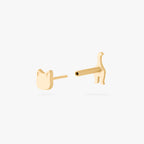 Gold cat earring on white background