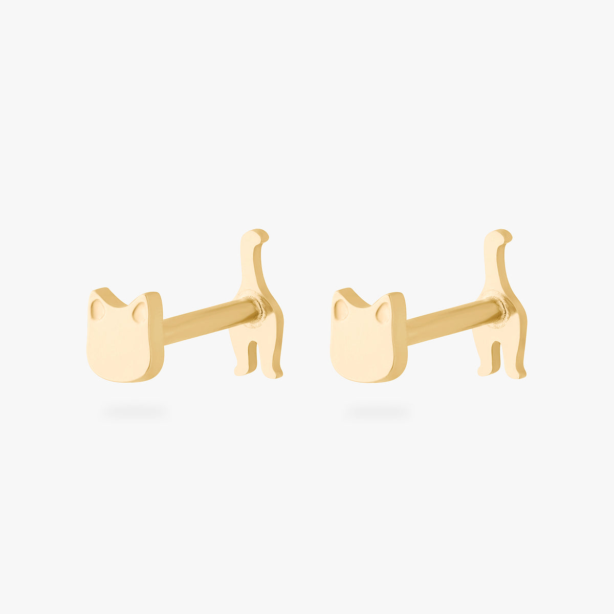 Two gold cat-shaped earrings on a white background