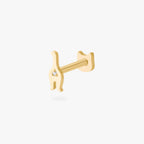 Gold cat earring with gemstone on white background