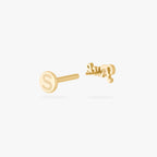 Gold stud earring on a white background showing earring back