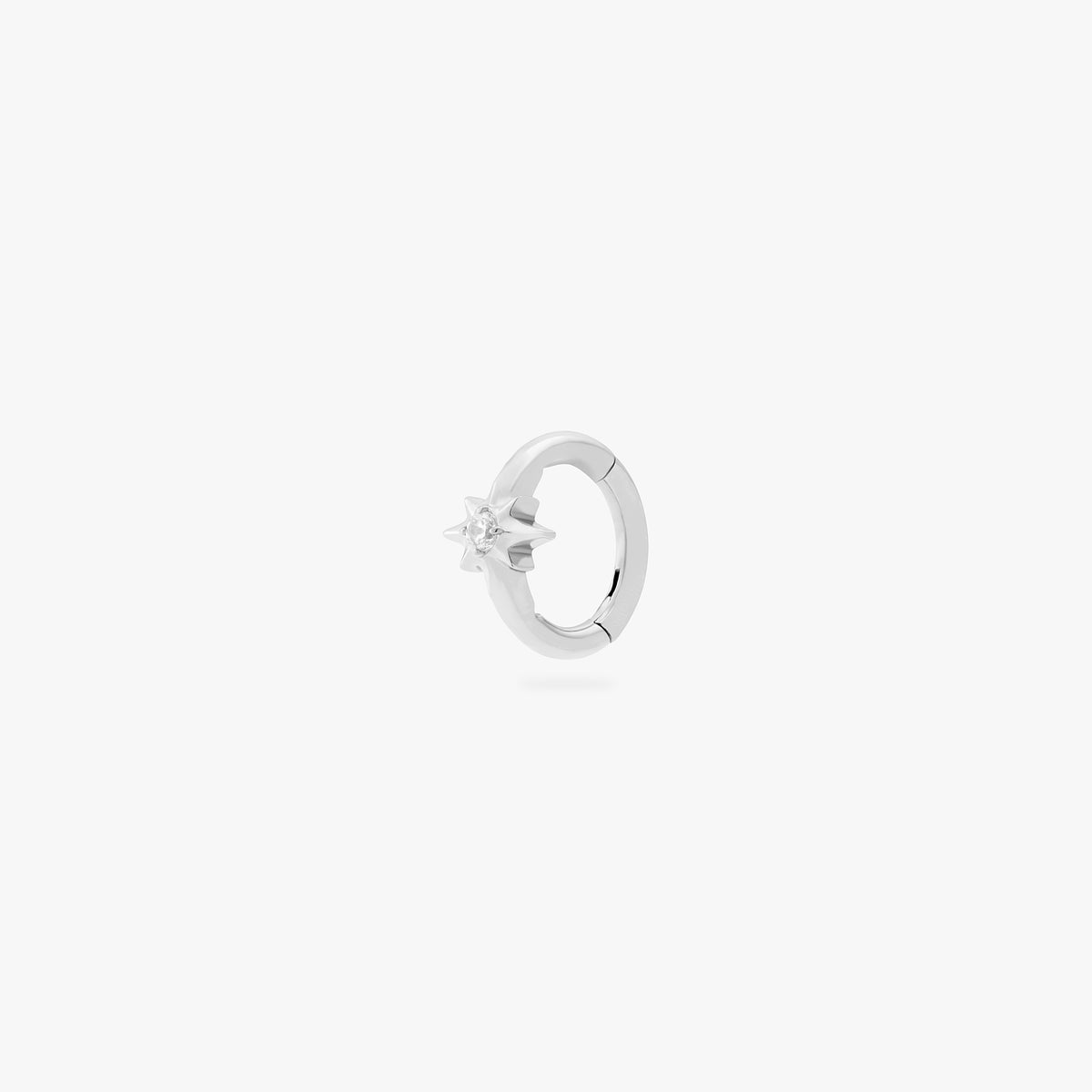 This is an image of a silver-toned titanium clicker with a twinkle-star shape that features a crystal CZ in the center. This clicker is 6mm in diameter.