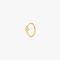 A single gold earring with a star-shaped stone, shown against a white background.