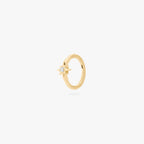 A single gold earring with a star-shaped stone, shown against a white background.