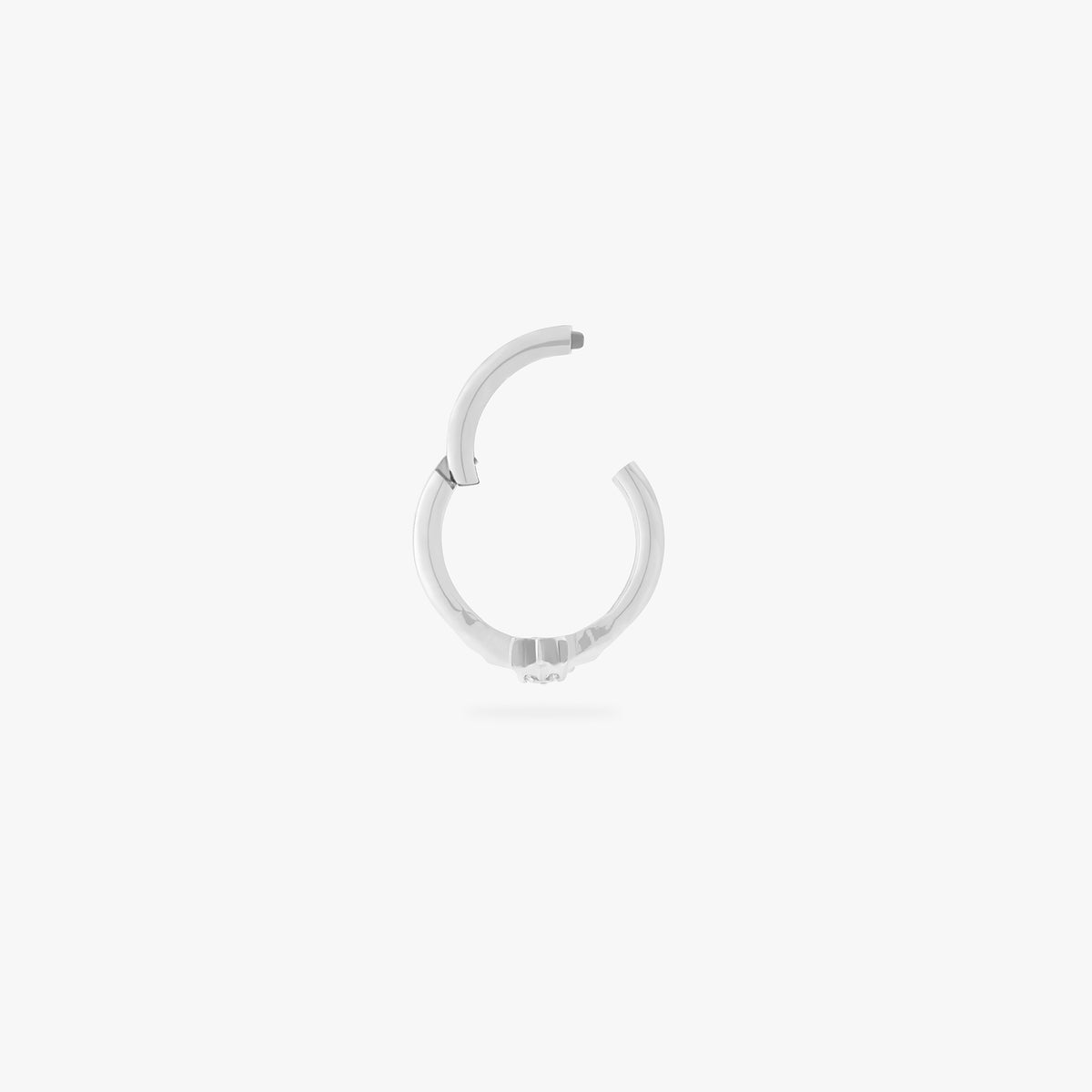 A single silver earring with a star-shaped stone, shown against a white background. This clicker is hinged open in this image.