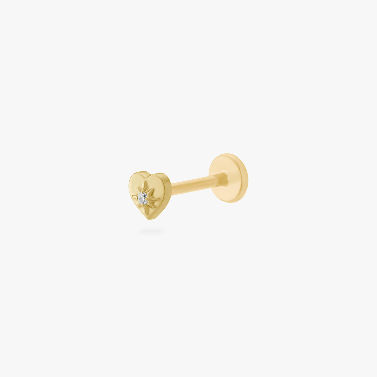 This is an image of a gold-toned titanium flatback stud in the shape of a heart with a twinkle shaped star within it, and a crystal CZ within that. 