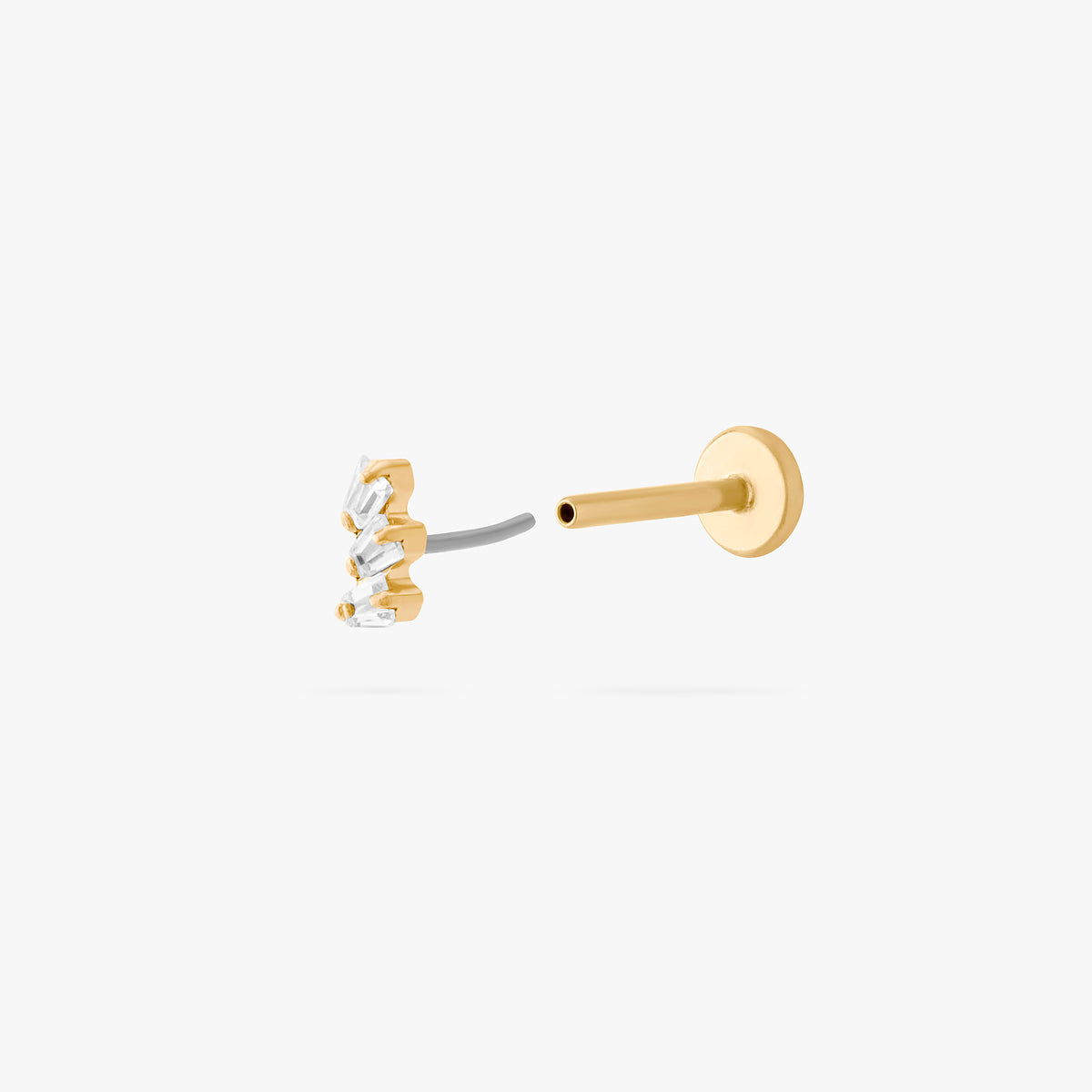 This is an image of a gold-toned titanium flatback stud with 3 micro baguette cut stones placed in a cluster. This image shows the earring facing the camera, separated from the flatback post. 