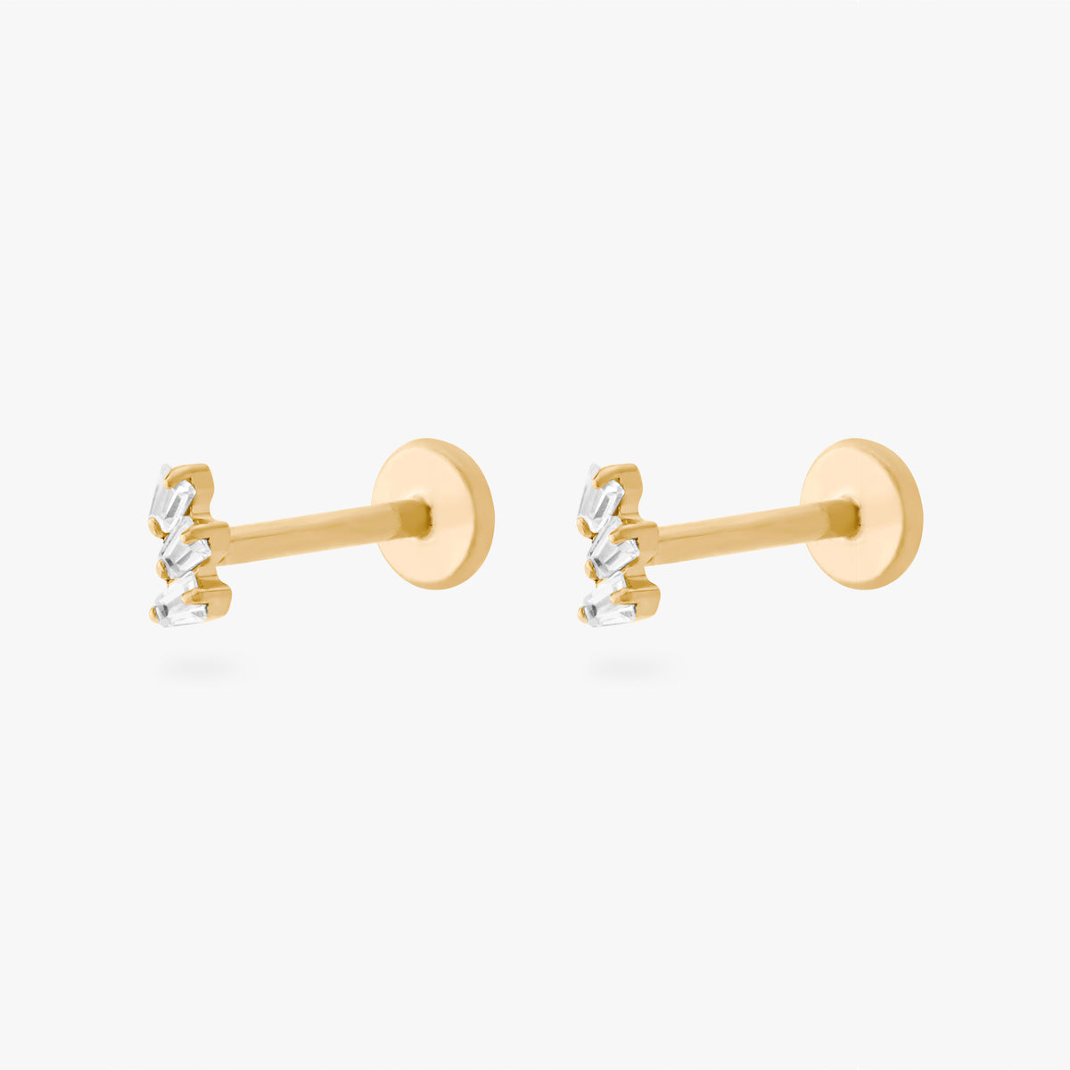 This is an image of a pair of gold-toned titanium flatback studs with 3 micro baguette cut stones placed in a cluster.