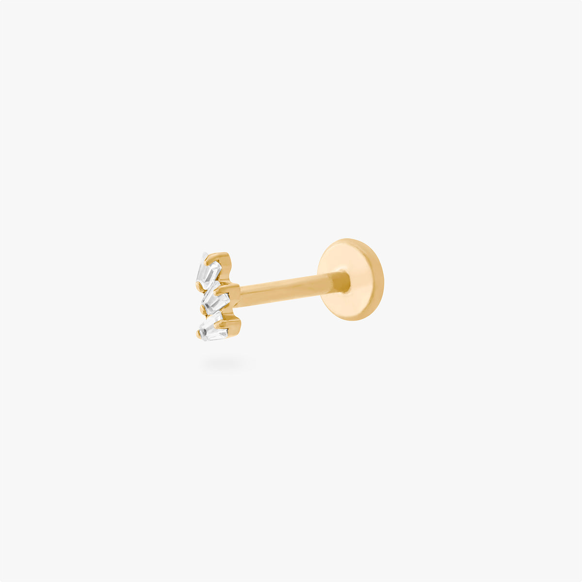 This is an image of a gold-toned titanium flatback stud with 3 micro baguette cut stones placed in a cluster. 