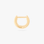 This is an image of a 14K gold plated huggie earring with 4 baguette cut, bezel set crystal CZs along the edge. 