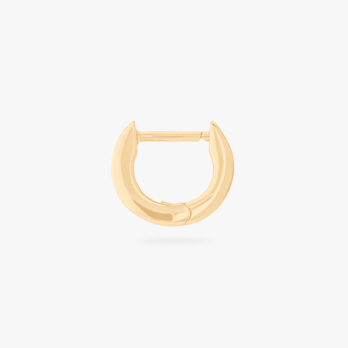 This is an image of a 14K gold plated huggie earring with 4 baguette cut, bezel set crystal CZs along the edge. 