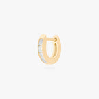This is an image of a 14K gold plated huggie earring with 4 baguette cut, bezel set crystal CZs along the edge. 