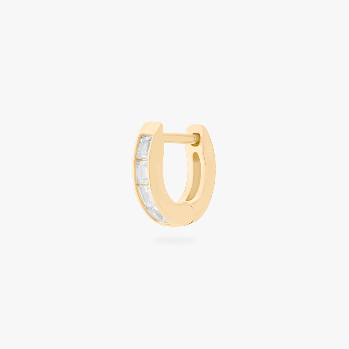 This is an image of a 14K gold plated huggie earring with 4 baguette cut, bezel set crystal CZs along the edge. 