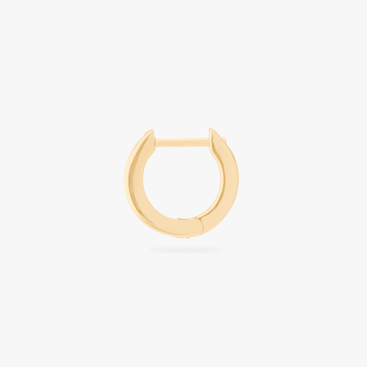 This is an image of a 14K gold plated huggie earring with 6 baguette cut, bezel set crystal CZs along the edge. 