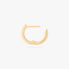This is an image of a 14K gold plated huggie earring with 6 baguette cut, bezel set crystal CZs along the edge. This image shows the huggie opened.