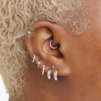 This is an image of a silver-toned titanium clicker with a twinkle-star shape that features a crystal CZ in the center circled on an ear. This clicker is 6mm in diameter.