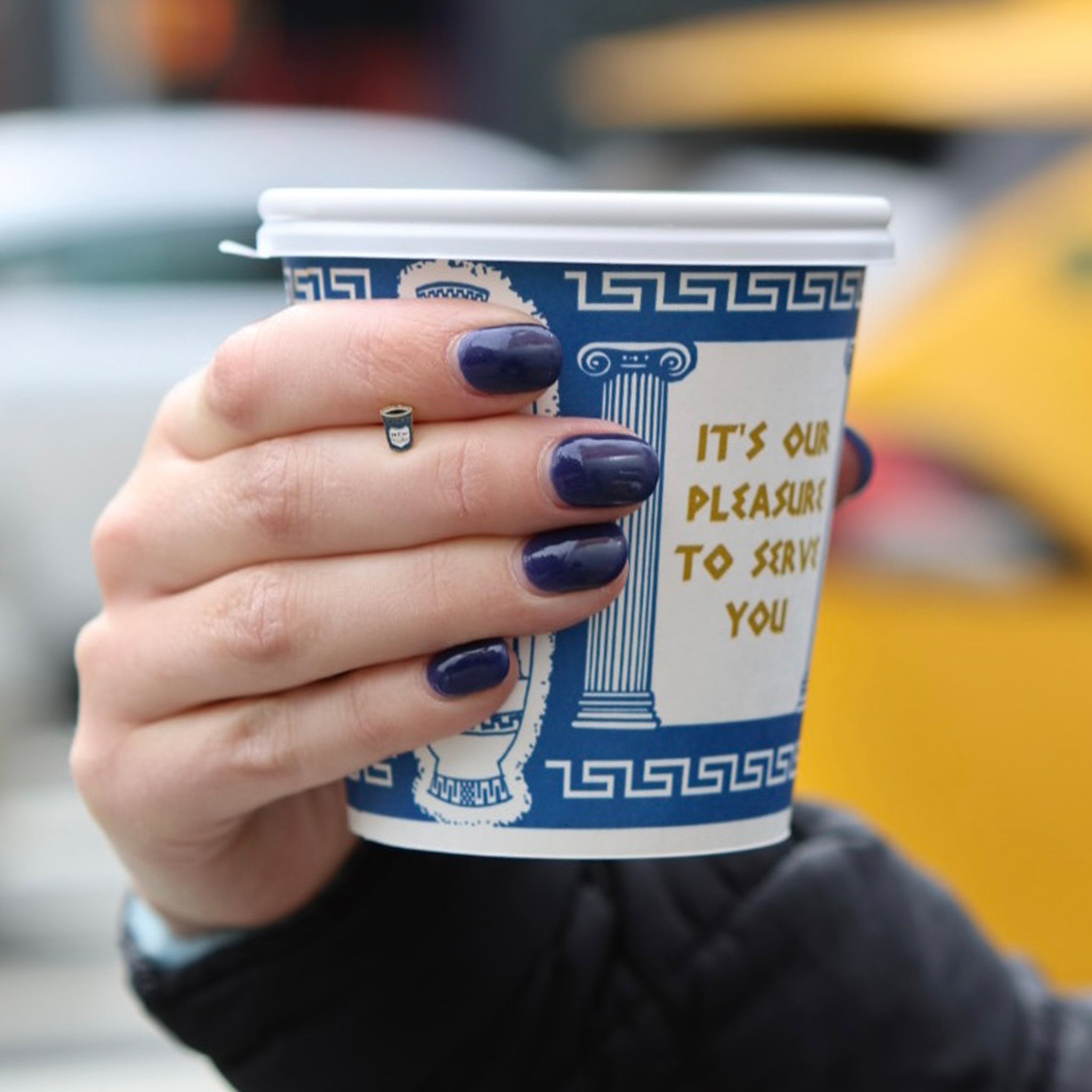 This is an image of a gold-toned flatback stud in the shape of a coffee cup with blue and white enameling. color:null|gold/blue