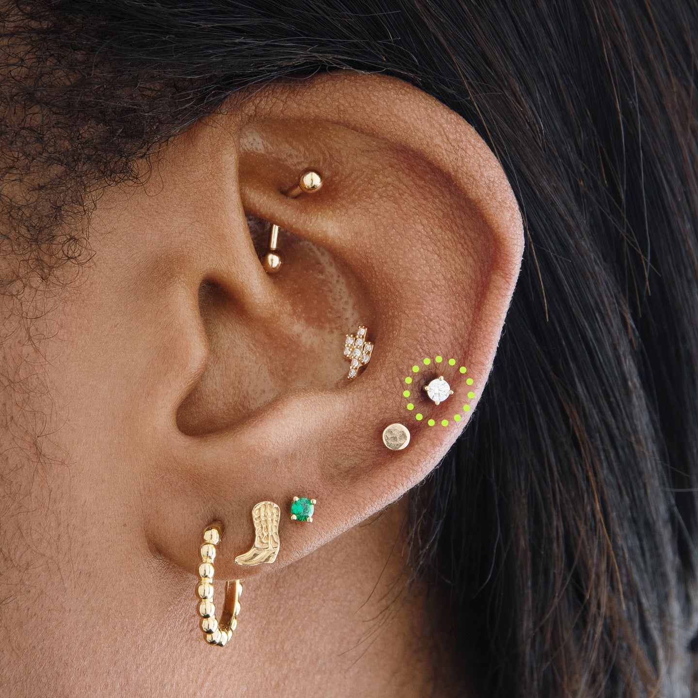 on ear image with a clear mini cz stud set in a 14k gold setting [hover] color:null|gold/clear