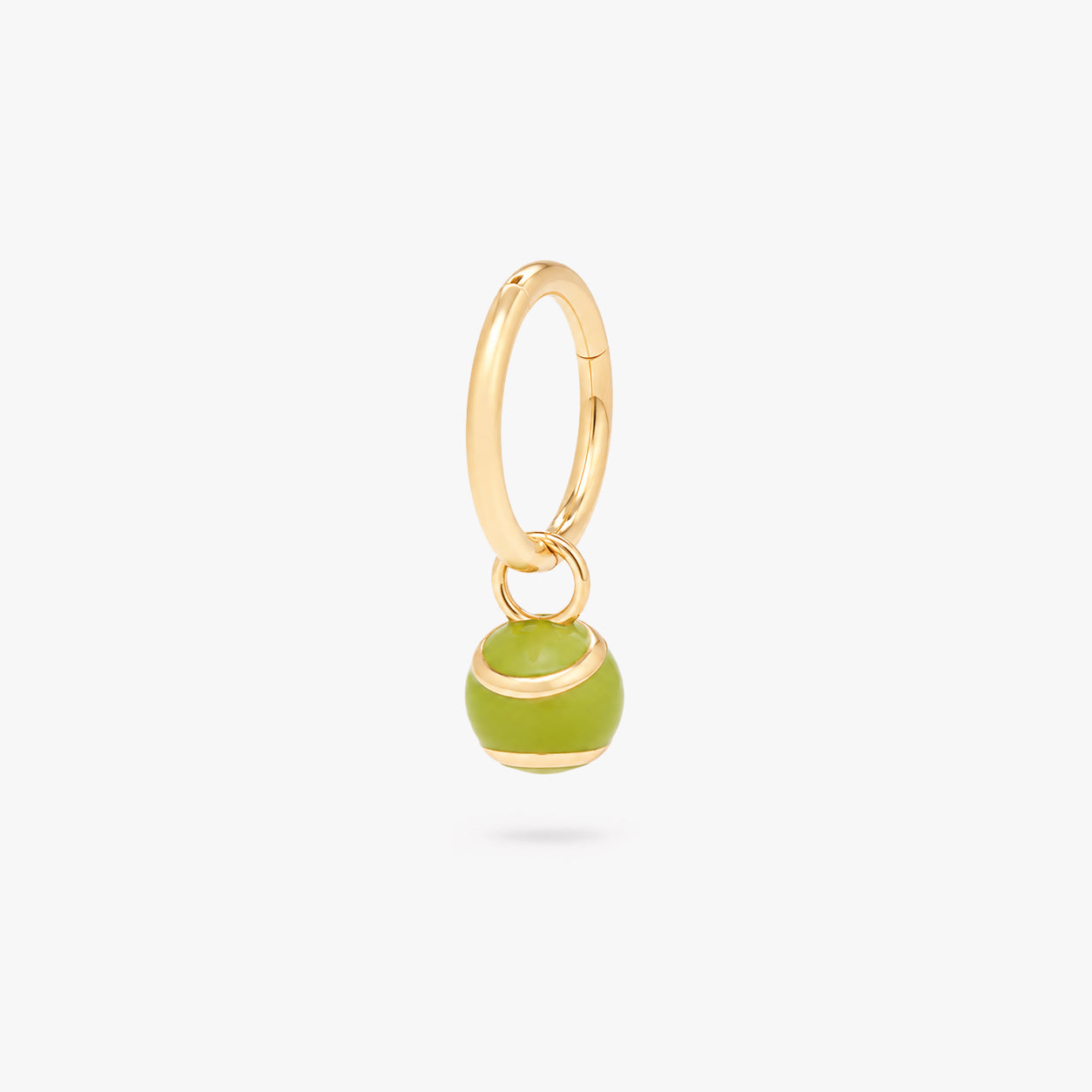 This image shows a green tennis ball charm on a gold clicker
