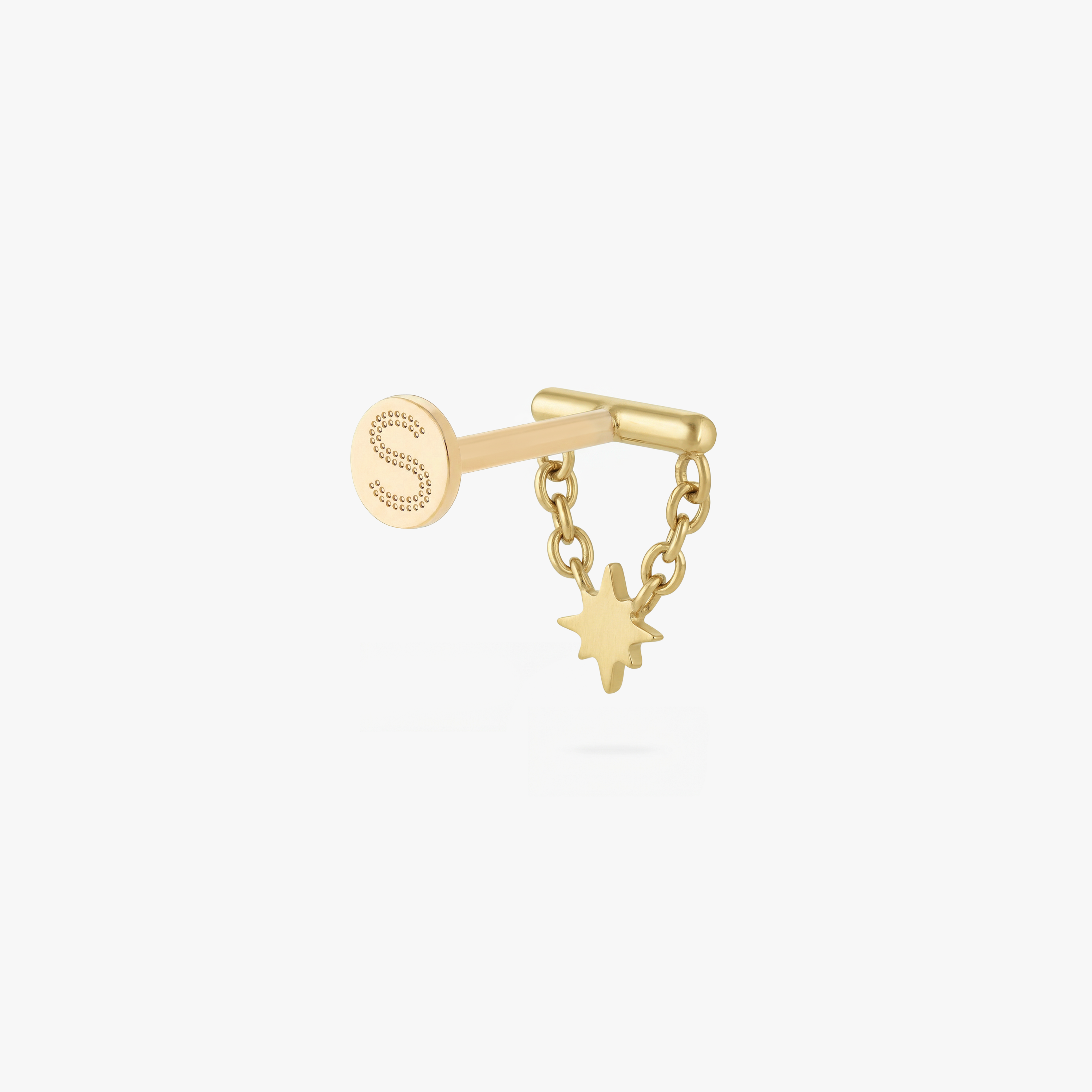 This is an image of a gold toned flatback stud which has a bar with chains from either side supporting a dangling twinkle star with a clear, round CZ center stone.