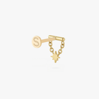 This is an image of a gold toned flatback stud which has a bar with chains from either side supporting a dangling twinkle star with a clear, round CZ center stone. 